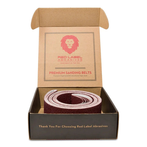 Open box of Heavy Duty 2 By 72 Inch Flexible Aluminum Oxide Sanding Belts Multipurpose For Wood Leather Rubber Plastic And Light Metalworking In 60 80 120 220 320 400 Grits 6 Pack
