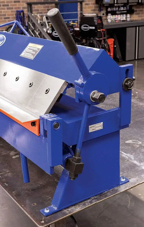Close-up side view of 48 Inch Pan And Box Sheet Metal Brake with adjustable removable fingers in blue for 135° bends, workshop setting.