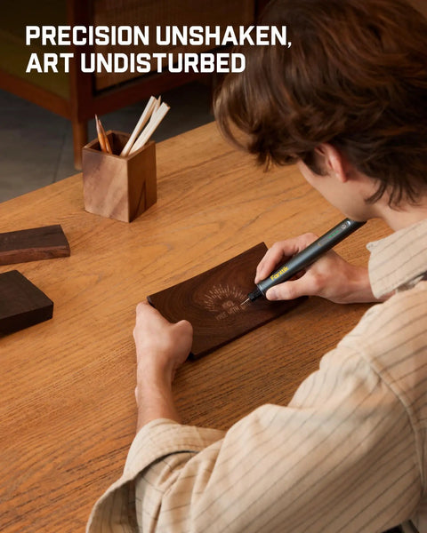 Person using Cordless Engraving Pen Kit With 5 Variable Speeds, Pro Grade Rechargeable Engraver Pen With 20 Bit Set on wood