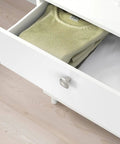 Six Pack Brushed Satin Nickel Cabinet Knobs Zinc Alloy Kitchen Hardware Smooth As Silk Finish on white drawer with folded sweater.