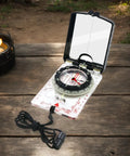 Trail Tested Direction Finder With Mirror Sight, Water Resistant Compass For Hiking And Trekking on wooden surface