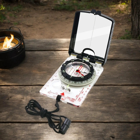 Trail Tested Direction Finder With Mirror Sight, Water Resistant Compass For Hiking And Trekking on wooden surface