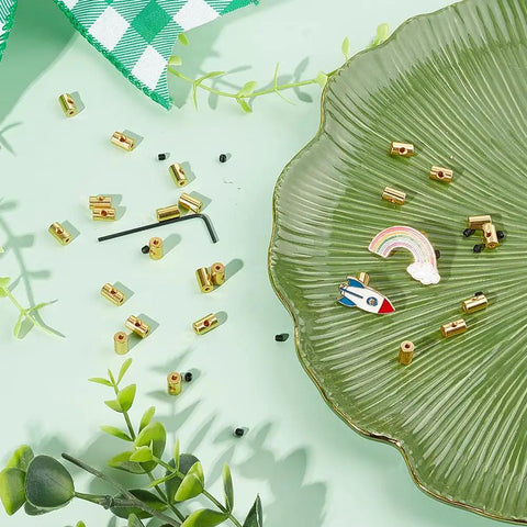 Locking Lapel Pin Backs Set With 30 Pcs Golden Brass Clips 30 Screws And Wrench For Jewelry Making Badges And Accessories Great For Christmas Weddings DIY Projects And Beginners To Pros on a green plate