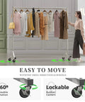 70 Inch Extra Long Garment Rack With Wheels Beefy Industrial Grade Heavy Duty Clothes Rack Chrome Finish Commercial Grade Rolling Clothes Rack Supports Up To 450 Lb displayed in a room with clothes hanging on it.