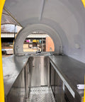 Interior view of stainless steel mobile kitchen in a food truck trailer, featuring sinks and spacious surfaces for food prep. Kickstart Your Side Gig With This Rock Solid Custom Concession Food Truck Trailer Loaded Up With A Full Stainless Steel Mobile Kitchen For Serving BBQ Coffee Or Ice Cream Right Wherever You Roll Up.