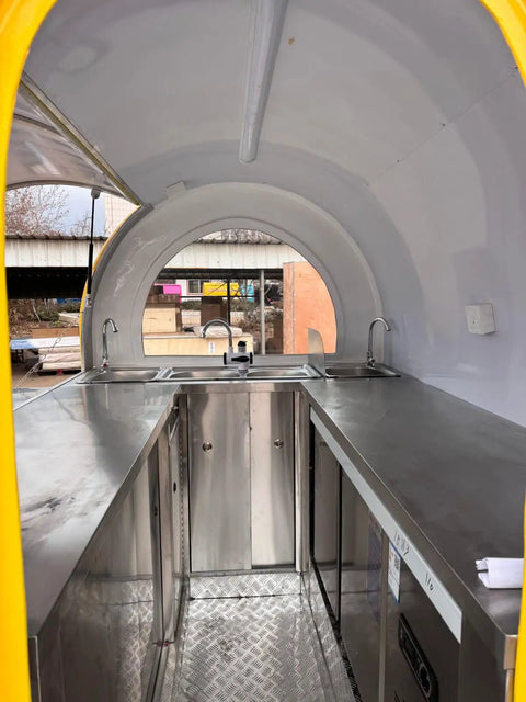 Interior view of stainless steel mobile kitchen in a food truck trailer, featuring sinks and spacious surfaces for food prep. Kickstart Your Side Gig With This Rock Solid Custom Concession Food Truck Trailer Loaded Up With A Full Stainless Steel Mobile Kitchen For Serving BBQ Coffee Or Ice Cream Right Wherever You Roll Up.