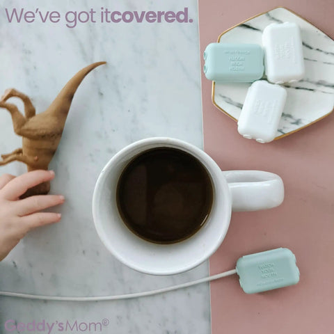 Kid Friendly USB Charger Covers 6 Pack Dusty Aqua, Child Resistant Cord Tip Enclosures, hand near coffee and toy