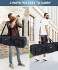 Two men carrying Beefed Up Heavy Duty Tripod Carrying Case Bag 50.5 Inch Long Waterproof Nylon Gear Case with various carrying options.