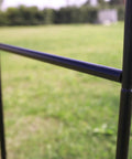 Close-up of a steel frame showing detail of Steel Garden Arch For Climbing Plants Backyard Vibes Outdoor Decor 7 Feet 8 Inches High And 4 Feet 5 Inches Wide Weather Resistant Black Epoxy Coated Easy Assembly Ideal For Vines And Flowers With Southern Charm For Your Lawn