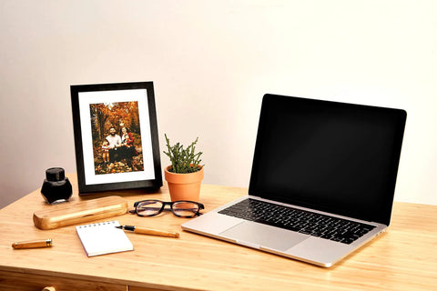 Photo Frame Diversion Safe With Hidden Compartment 4x6 Black Mini Safe Box on desk near laptop and plant
