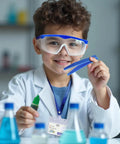 Child in lab coat holding tweezers and dropper, wearing goggles from Totally Fun Kids Science Costume Lab Coat Kit With Goggles ID Card Petri Dishes Dropper And Tweezers For Pretend Play Dress Up And Role Play Gift For Boys And Girls