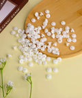 120 Pack White Pegboard Hook Stoppers Lock It Down And Keep Gear Secure Heavy Duty Silicone Safety Clips scattered on a wooden tray.