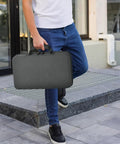 Person carrying Heavy Duty 88 Slot Knife Display Case For 64 Plus Pocket Knives, Butterfly Knife Storage Box in Grey outdoors