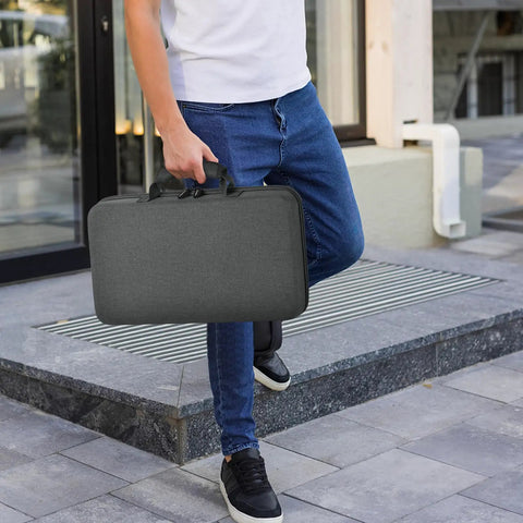 Person carrying Heavy Duty 88 Slot Knife Display Case For 64 Plus Pocket Knives, Butterfly Knife Storage Box in Grey outdoors