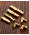 4 Pcs Copper Invisible Concealed Barrel Hinges For Jewelry Boxes And Lil Cabinets arranged on wooden surface