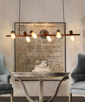Industrial chandelier with 4-Pack Dimmable Vintage Edison Light Bulbs, Amber Glass ST64, 40W Equivalent, in a cozy farmhouse setting.