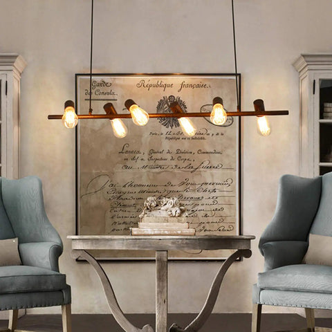 Industrial chandelier with 4-Pack Dimmable Vintage Edison Light Bulbs, Amber Glass ST64, 40W Equivalent, in a cozy farmhouse setting.