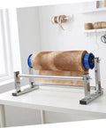 Manual Stretch Film Dispenser Stand For Shipping Supplies Hand Operated Wrap Film Holder With Metal And Plastic Construction Lightweight Yet Sturdy For Easy Desktop Wrapping And Efficient Warehouse Or Home Packing.