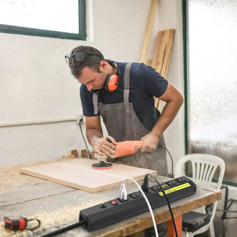 Built Tough Heavy Duty 20 Amp Power Strip With 6 Widely Spaced Outlets in use at a workshop with power tools on a wooden table