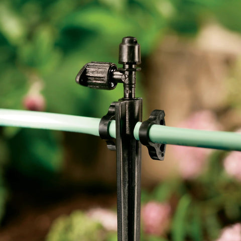 Orbit 67710 black high-pressure tubing clamp for 1/4-inch irrigation tubing on stake (front view)