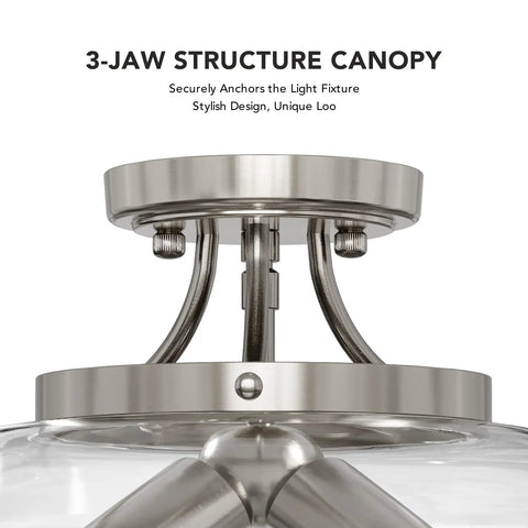 Close-up of 3-jaw canopy on a modern ceiling light fixture with clear glass shade, brushed nickel finish.