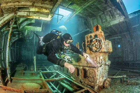 Diver exploring wreck using Zen Deluxe Single Tank Scuba BCD With Narrow Zen Wing For Superior Buoyancy Control, Stainless Backplate