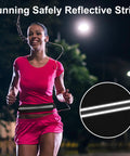 Waterproof Running Belt Fanny Pack For Men And Women Slim Running Bag with reflective strip, worn by runner at night.