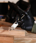 Slick Precision Wood Glue Syringe With Replaceable Tips for Tight Joints and Crafts held over wood pieces.
