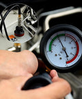 Close-up of Streetwise 14 Piece Coolant Pressure Tester Kit With Manual Pump, showing gauge and hand holding hose.