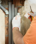 Person installing insulation foam tube for pipes and mini split lines, half inch inner diameter, nine millimeter wall, one meter length