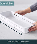 Expandable Sliding Drawer Bin For Kitchens Sets The Bar Inside Deep Drawers The Adjustable Storage Tray In Speckled White shown being extended.