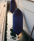 Keep Your Boat Spotless At The Dock With This Inflatable Fender Velvet Hull Protector hanging securely on a boat.