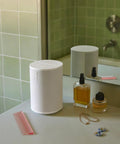 Era 100 SL Dope Compact Microphone Free Wireless Speaker With WiFi Bluetooth Line In on bathroom counter