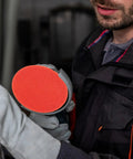 Close-up of Rock Solid 2000 Grit Orange Nylon Sanding Discs With Hook Loop Design for car repair and sanding projects.