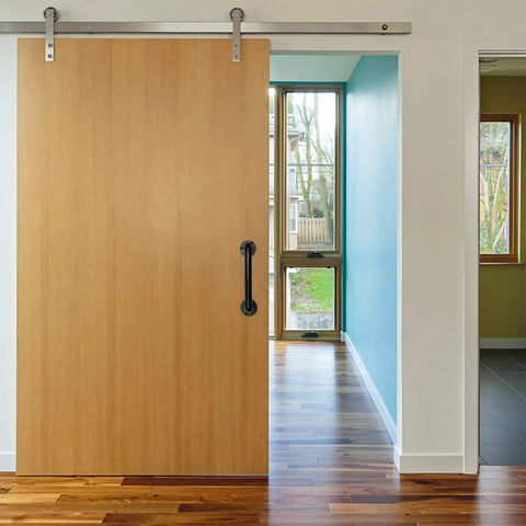 Sliding door with Industrial Pipe Door Pull Handle 12 Inch Black Rustic Grab Bar installed, highlighting black cast iron on wooden door.