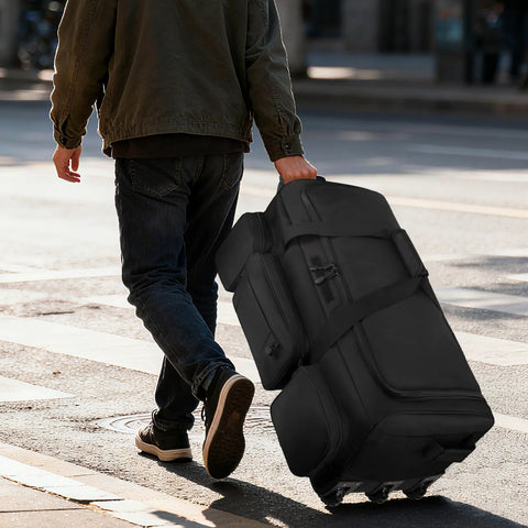 Person rolling military grade rolling duffle bag on street