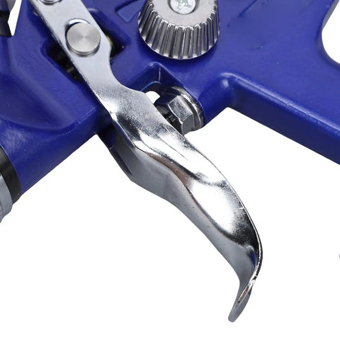 Close-up of the trigger mechanism of the Top Tier Gravity Feed Hvlp Spray Gun With Six Hundred Cc Cup for detailed painting.