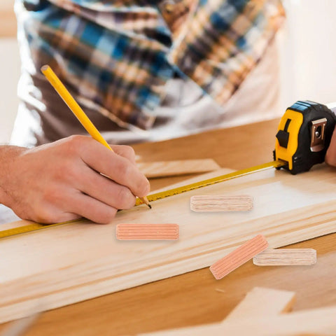 Person measuring wood with tape, Wooden Dowel Pins M8x30mm For Furniture Assembly Solid Round Dowels In Beige on table