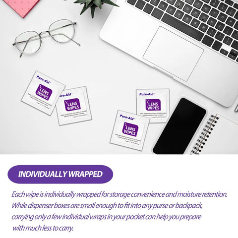 Lens wipes packets, five individually wrapped, on a white desk with laptop and eyeglasses.