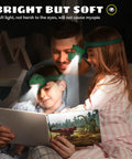 Family reading with Dinosaur Headlamp For Kids And Adults With Four Modes LED Headlamp, showing dinosaur book at night.
