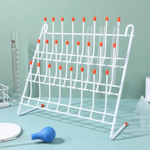 Compact Lab Glassware Drying Rack For Beakers And Flasks, white steel stand with orange tips, holds test tubes.
