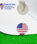 Six Piece Golf Ball Markers With Magnetic Hat Clips Value Set shown clipped to white cap, featuring USA flag design.