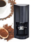 58 mm Automatic Espresso Tamper With Auto Sensor Detection And Push Button Pressure Controls To Pull Silky Smooth Shots That Taste Legit Every Single Time At Your Home Cafe next to coffee beans and ground coffee.