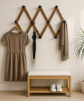 Expandable Accordion Wall Rack For Hats Coats Scarves And Purses Wood X Shape Coat Organizer with dress, umbrella, scarf on pegs.