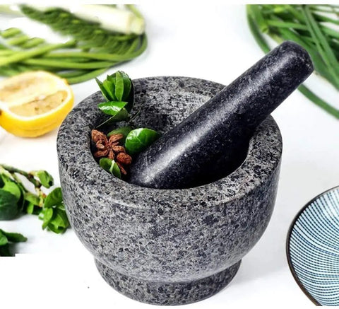 Granite mortar and pestle set with herbs, showcasing Mortar And Pestle Set Granite Spice Grinder 2 Cup Capacity With Anti Scratch Slip Base.