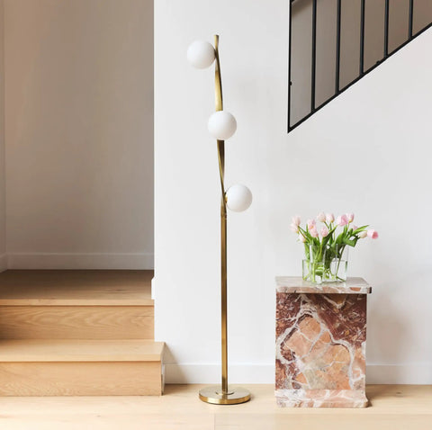 Nola Mid Century Modern 3 Globe Floor Lamp For Living Room And Office, LED Gold Finish Pole, near marble table with pink flowers