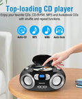 Person using Portable CD Player Boombox With FM Radio Bluetooth USB Port And Aux Input For Home Or On The Go Compact Easy Use Design