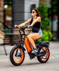 Blue Fat Tire Electric Bike For Epic Mountain Trails And Smooth City Cruising With Killer Torque Hella Durable Frame Long Range Battery Plus Utility Bike Bag For Zero Hassle Daily Rides, woman riding in city.