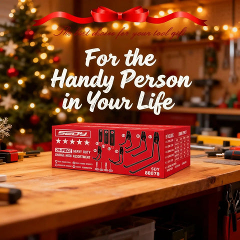 Product box labeled '20-Piece Heavy Duty Garage Hook Assortment' on a workbench, with festive background and Christmas tree.