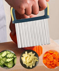 Stainless steel crinkle cutter with blue and yellow handle; veggie slicer for carrots, cucumbers, and potatoes